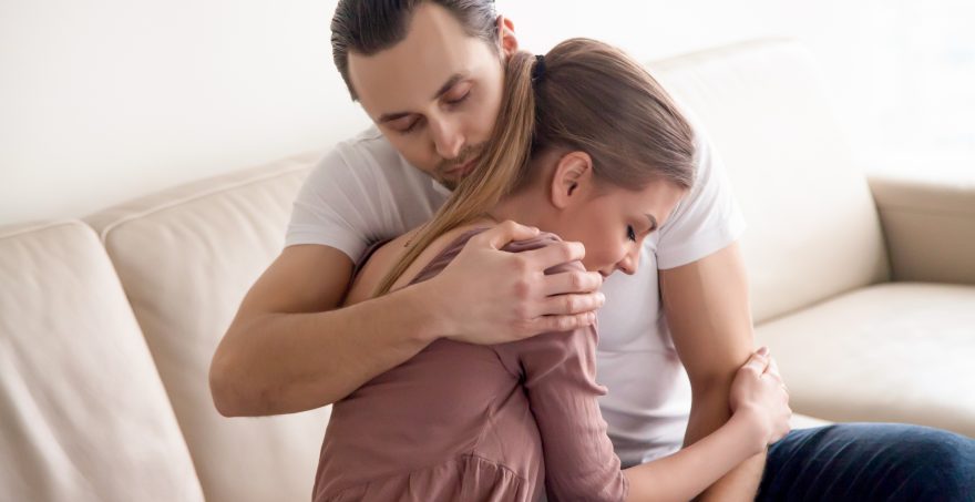 A married couple emotionally huging after a wife ordered a marriage love spell to restore love