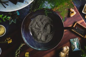 Salt and charcoal ritual ingredients on a plate