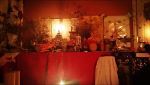 Prof. Eric Galandi in a candle-lit setting, performing a spiritual love ritual.