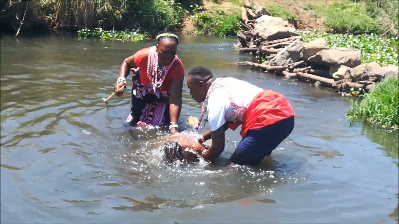 Prof. Galandi performing a love spell at the sacred Swazi river site