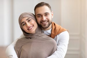 Muslim-Christian couple holding hands after interfaith spell healing