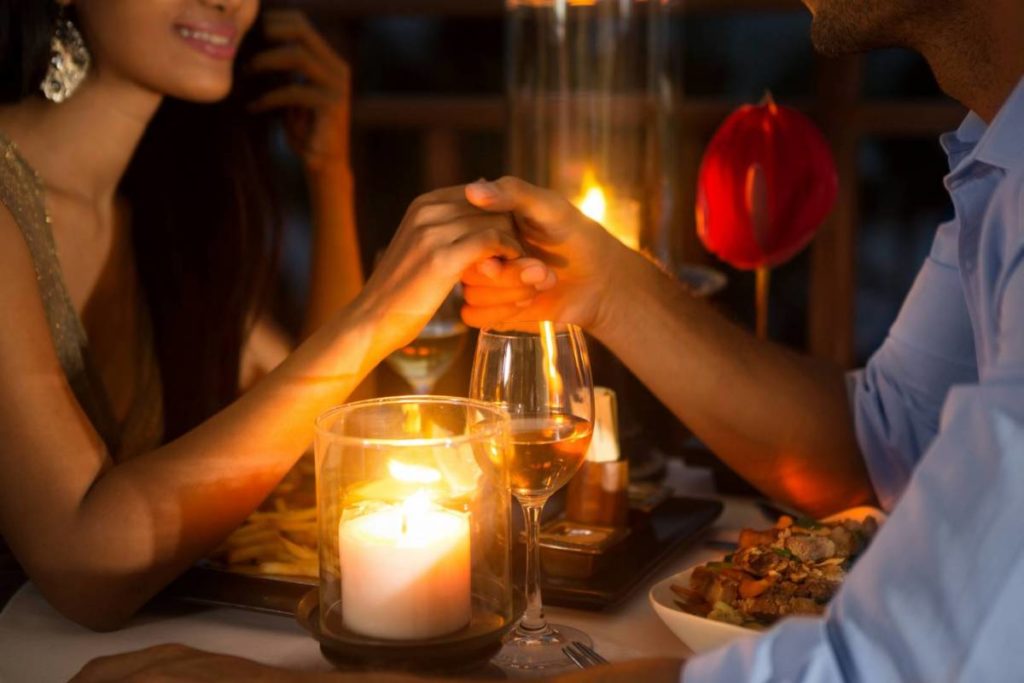 Happy couple with candlelight dinner