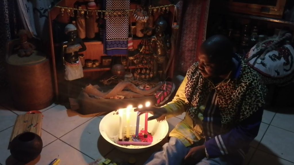 African spiritual healer performing cleansing and ancestral protection ritual.