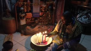 African spiritual healer performing cleansing and ancestral protection ritual.