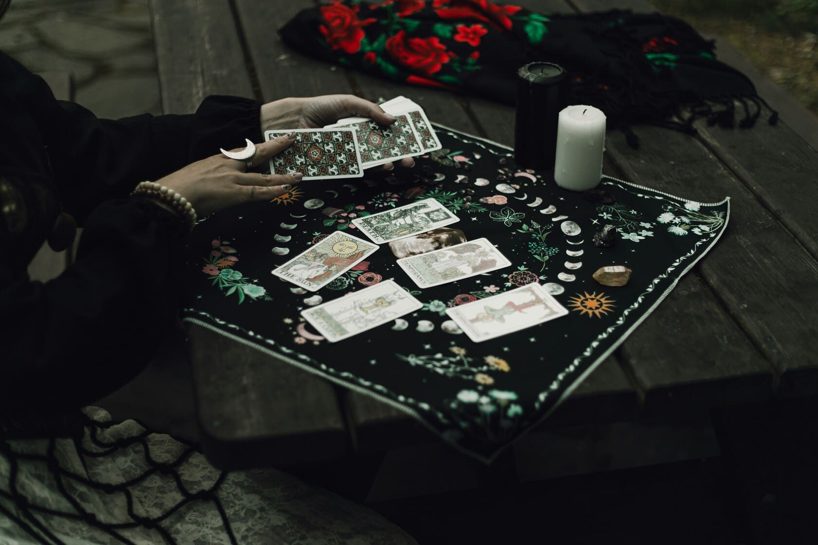 A mystical revenge spell setup with black candles and ritual tools.