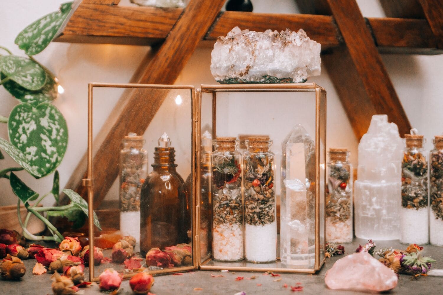Traditional love spell ingredients including herbs, candles and crystals arranged on a spiritual altar.